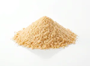 A pile of tan pyridoxine (vitamin B6) powder on a white background