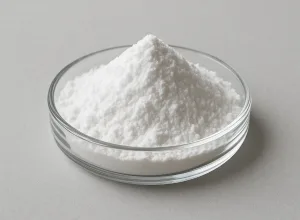 A glass dish of fine white pantothenic acid (vitamin B5) powder