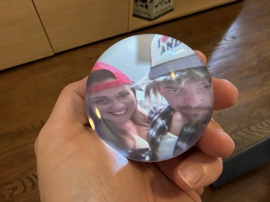 Memory Orb in a hand showing a photo of a couple