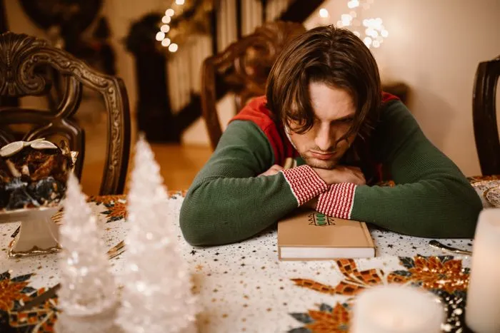 Man looking sad at a Christmas dinner table